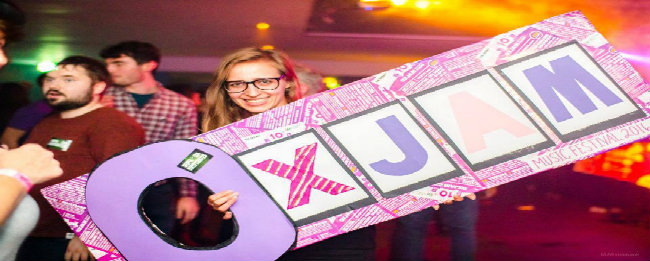 Image of someone holding an Oxjam sign
