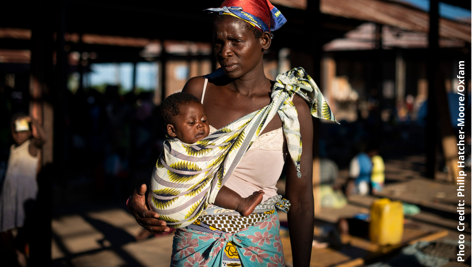 Malita, 35, stands with her four-month old son, Joseph*, in the hanger where she sleeps in the Bangula camp, southern Malawi